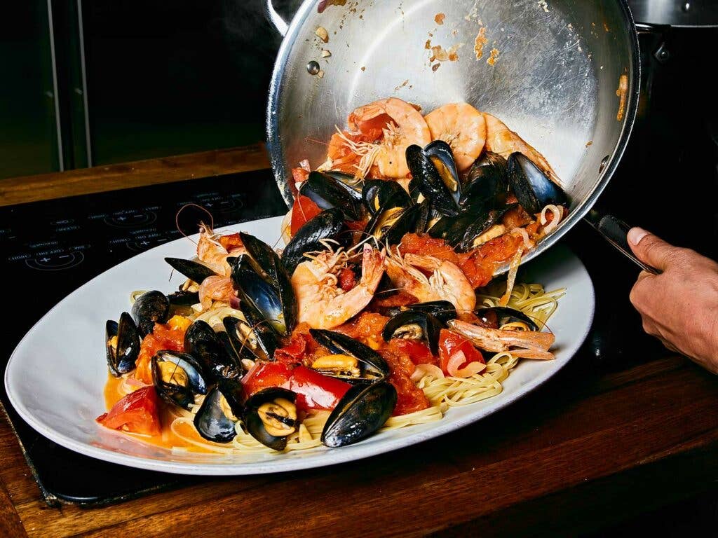 Seafood Pasta with Tomatoes, Chiles, and Mint served on platter.