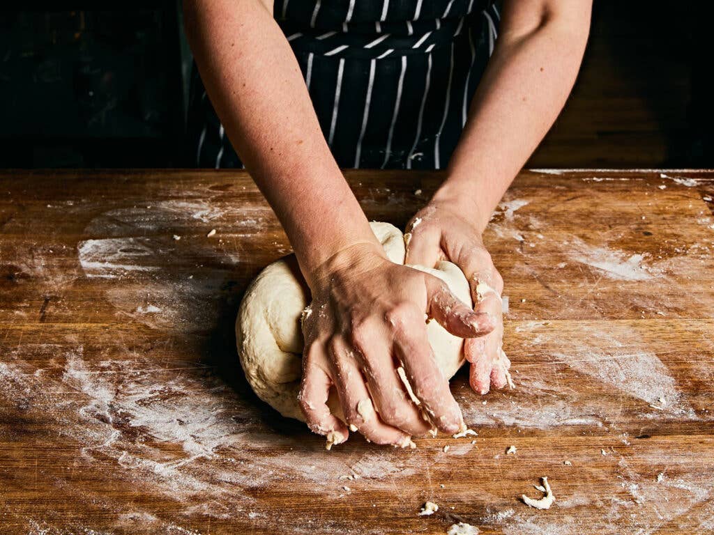 Mixing flour for pizza dough.