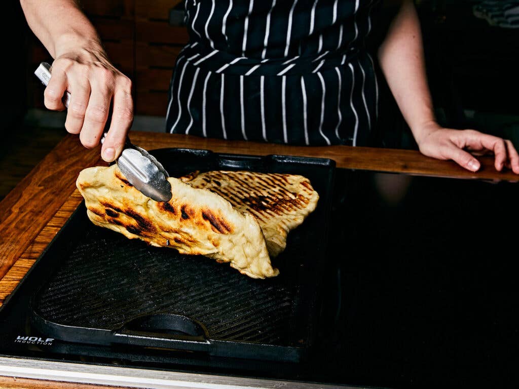 Charring pizza crust on grill pan.