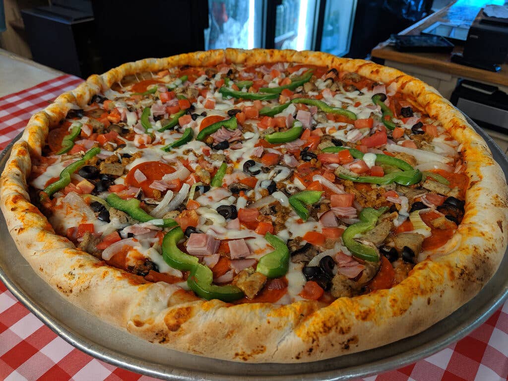 Veggies and meats on pizza at The Islander restaurant.