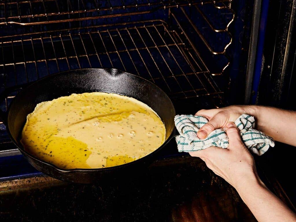 Swirling the olive oil and farinata batter.