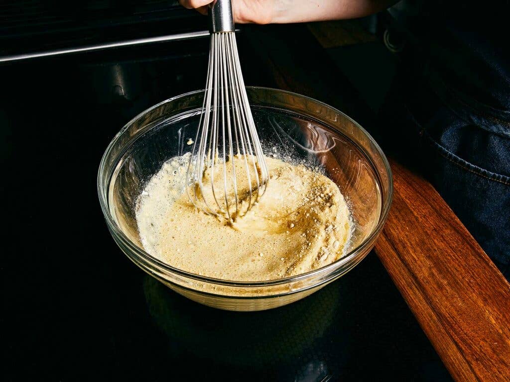 Whisking the farinata batter.