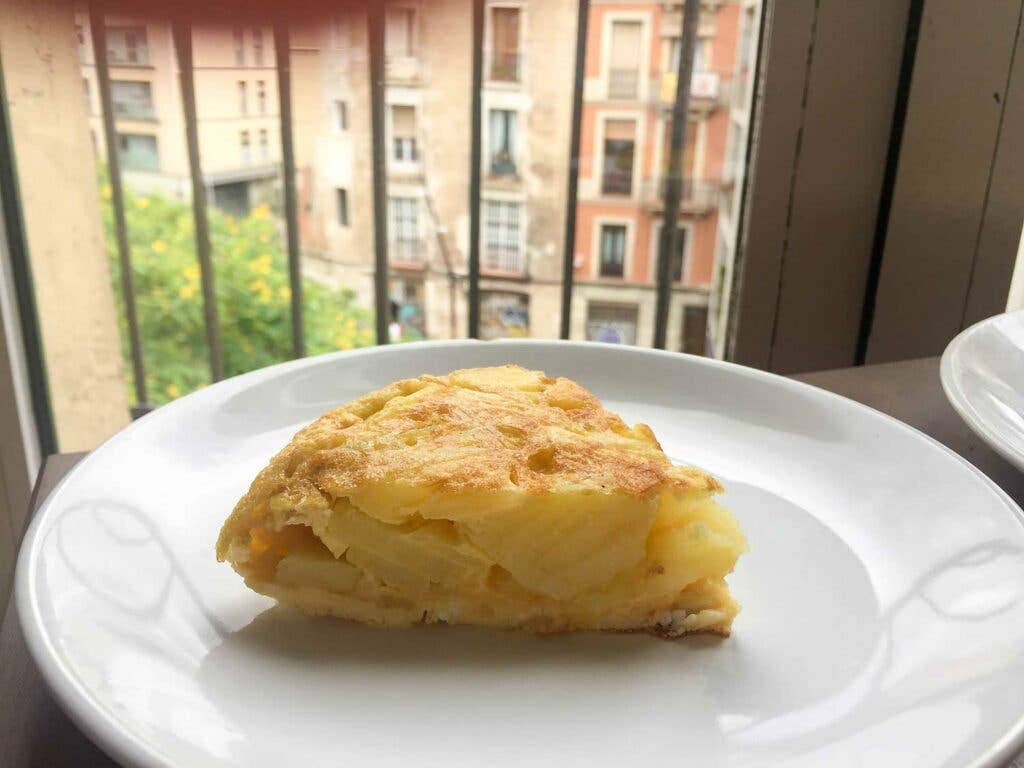 Spanish tortilla on white plate.