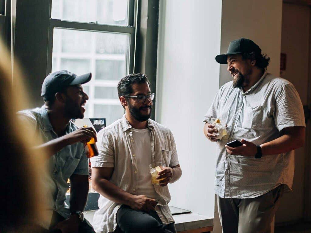 Guests enjoying cocktails made with Jamaican rum and lemongrass.