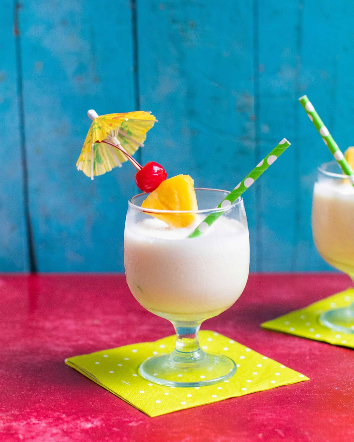 Frozen pina colada with umbrella and cherry on top