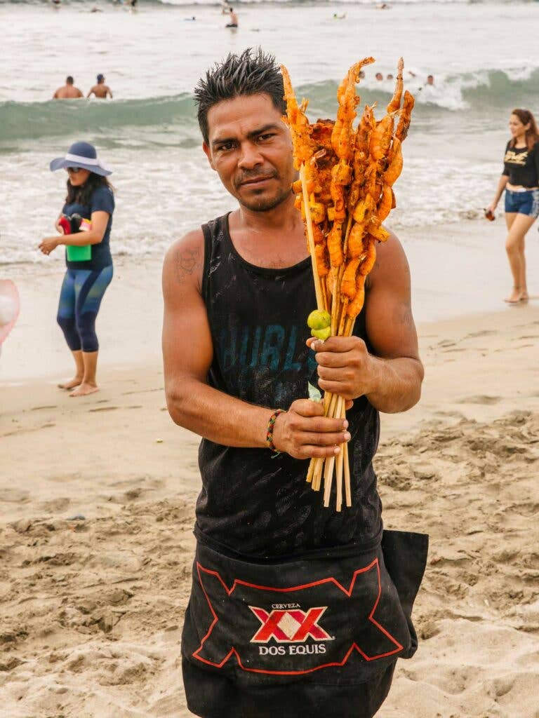 A pescado embarazado hawker at a bustling beach in Sayulita.