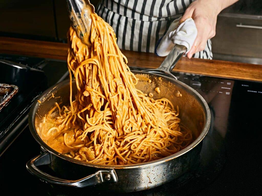 Stir and toss the pasta and shrimp in the sauce until both are just cooked through.