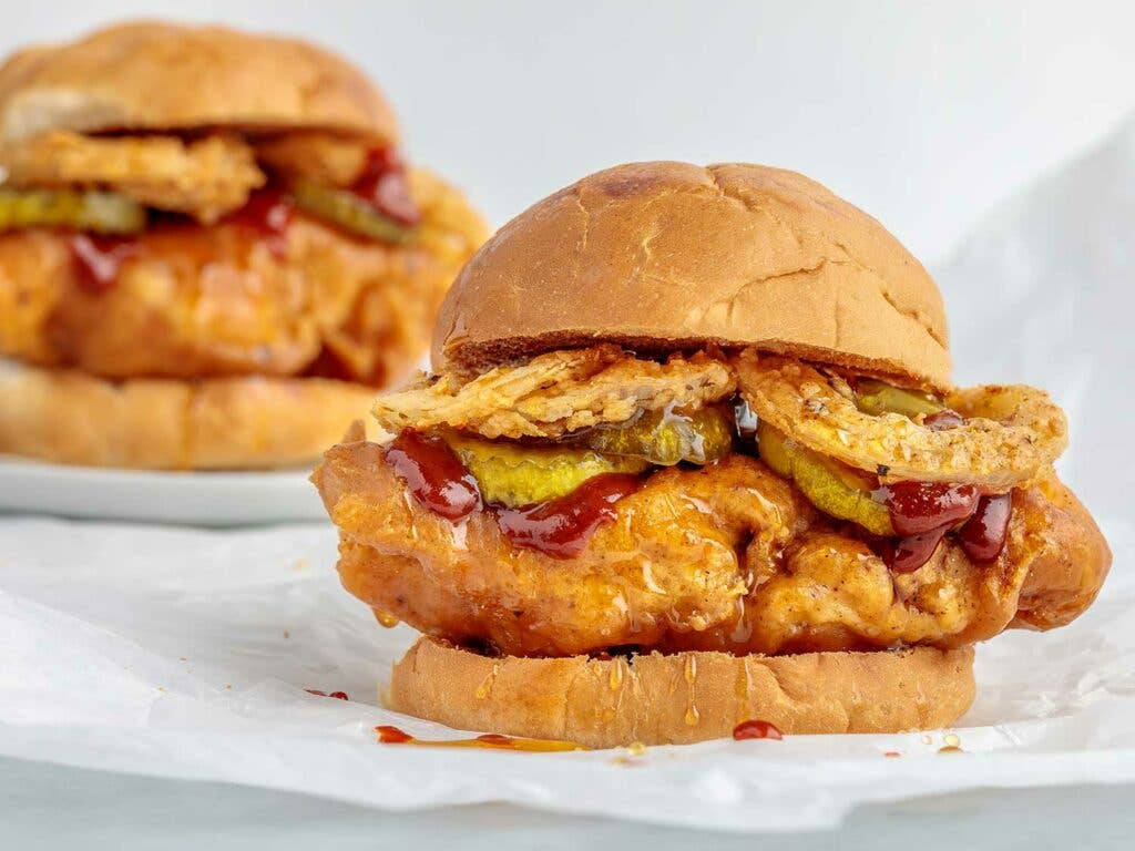 Cayenne and ancho chili battered crispy chicken sandwich glazed with Sriracha and honey, topped with pickles and fried onions.