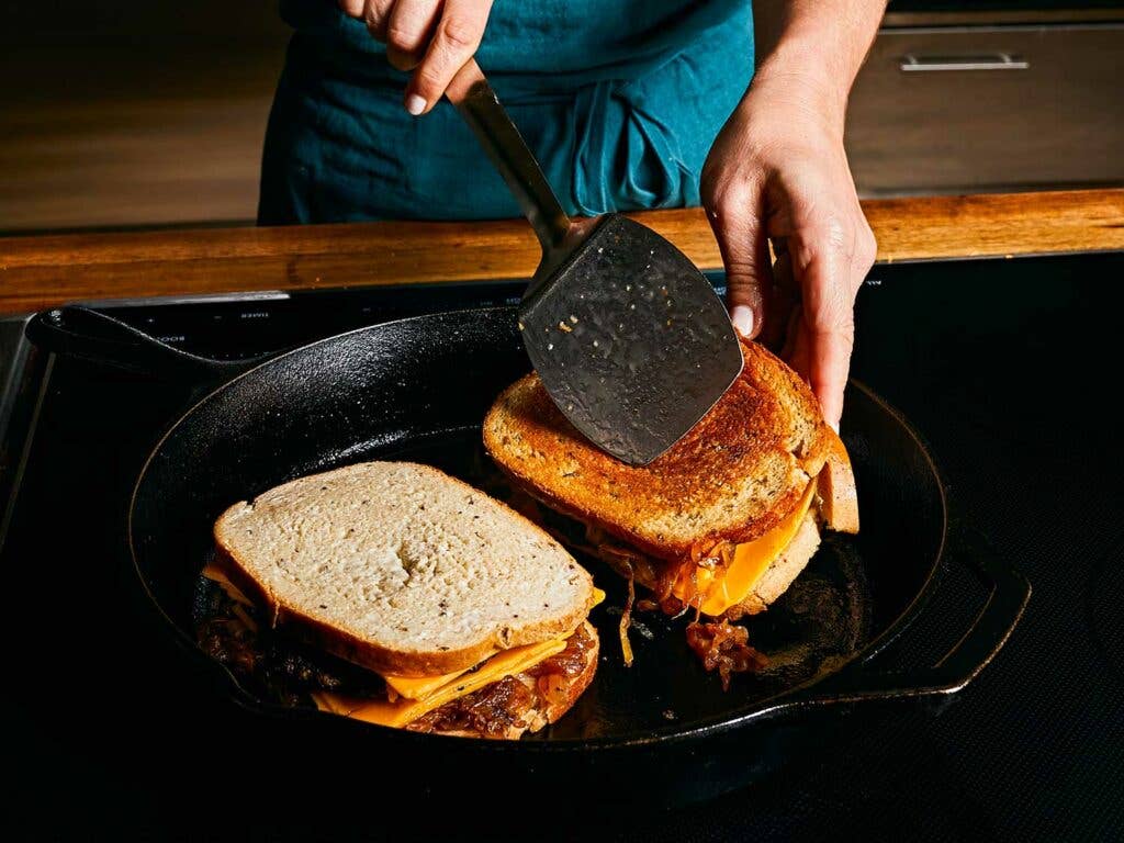 Pan searing finished sandwich in the cast-iron skillet until evenly golden.