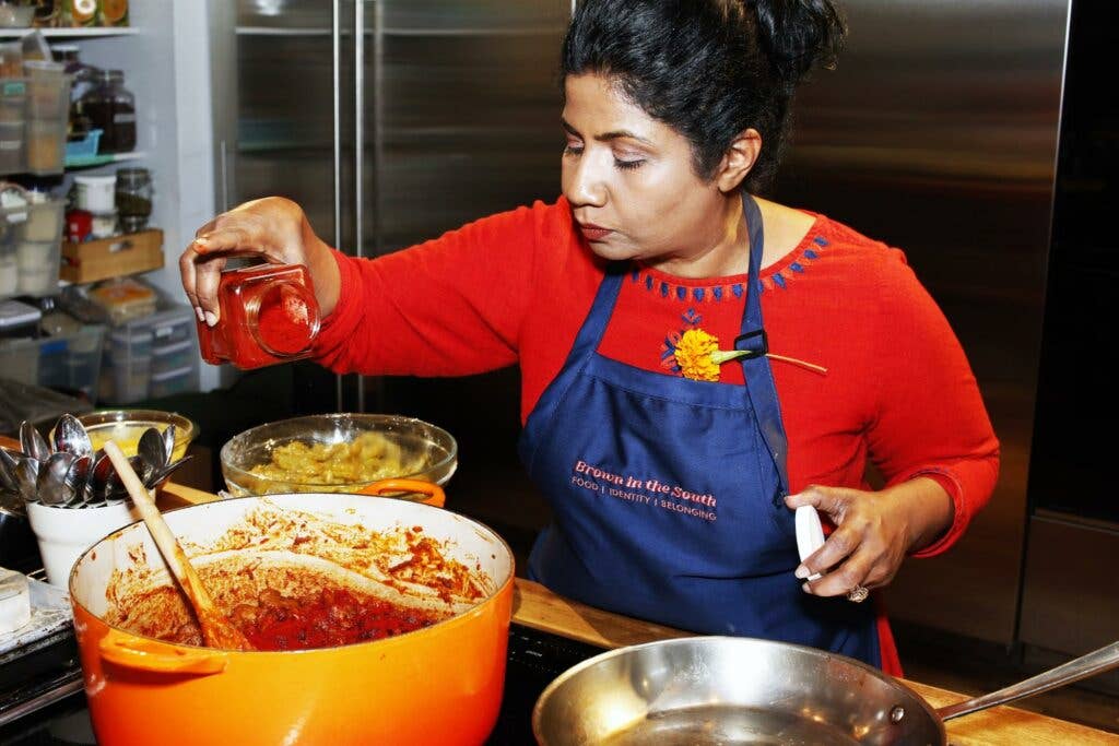 Asha Gomez preparing pork vindaloo