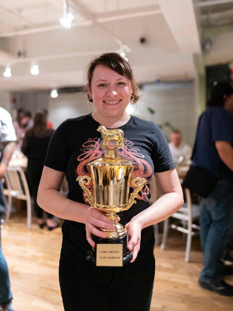 Chef Liz Barwick holds her Lamb Jam master trophy.