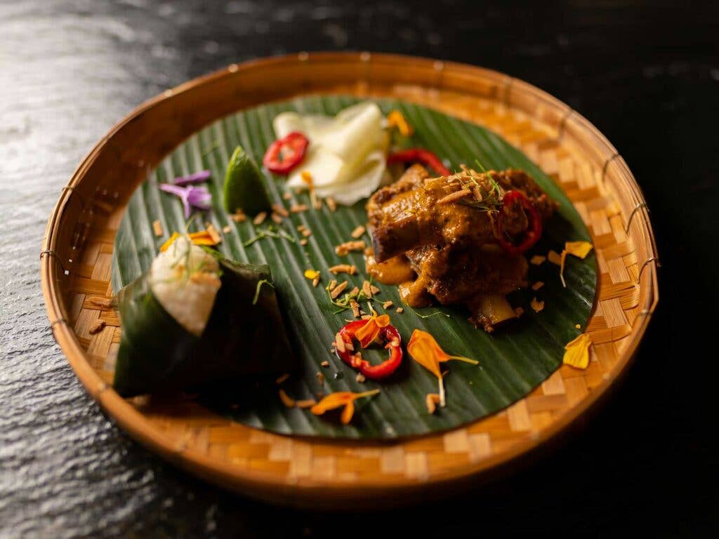 Coconut rice and pickled papaya served on the side.