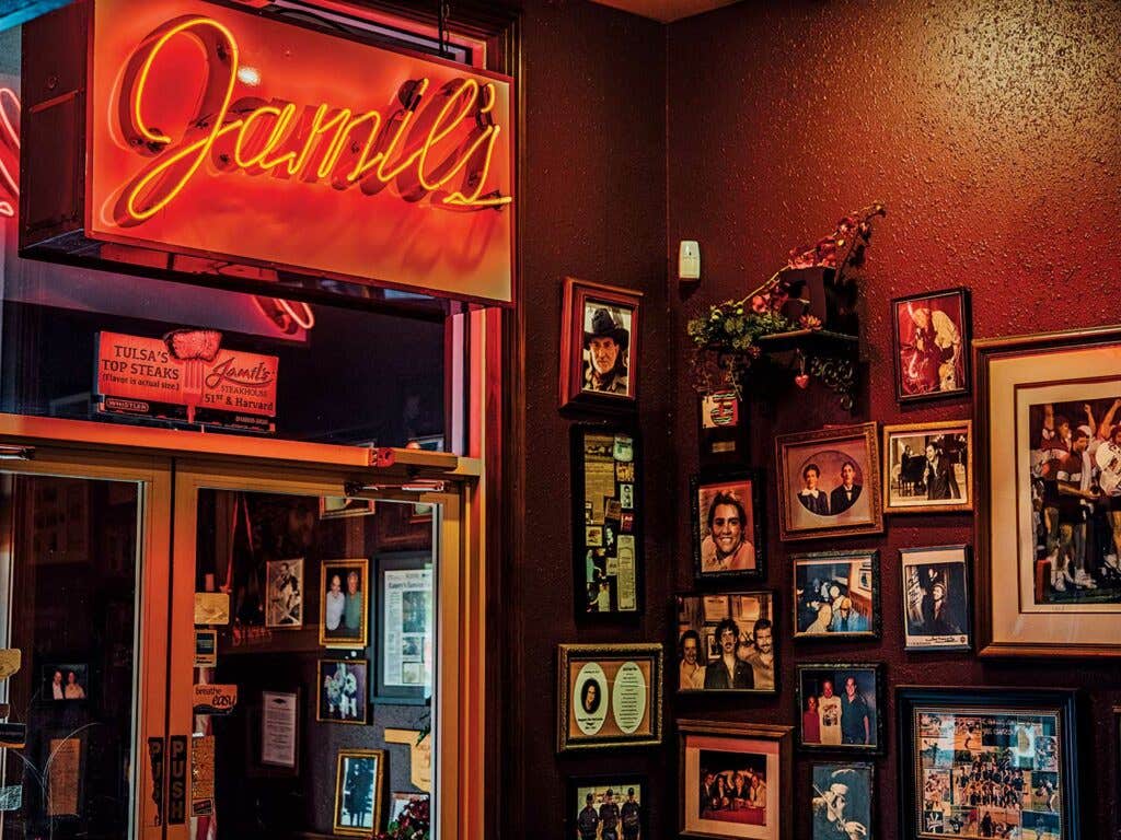 Custom neon and a wall of distinguished visitors to Jamil's restaurant.