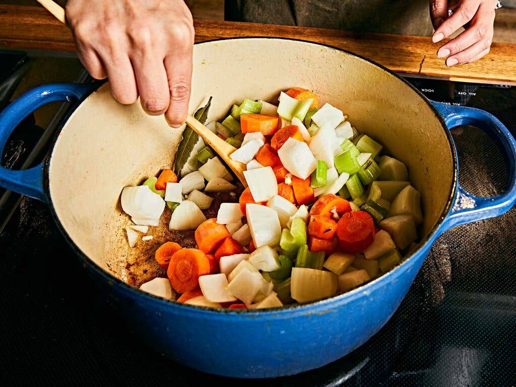 Carrots, celery, and onions in pot.