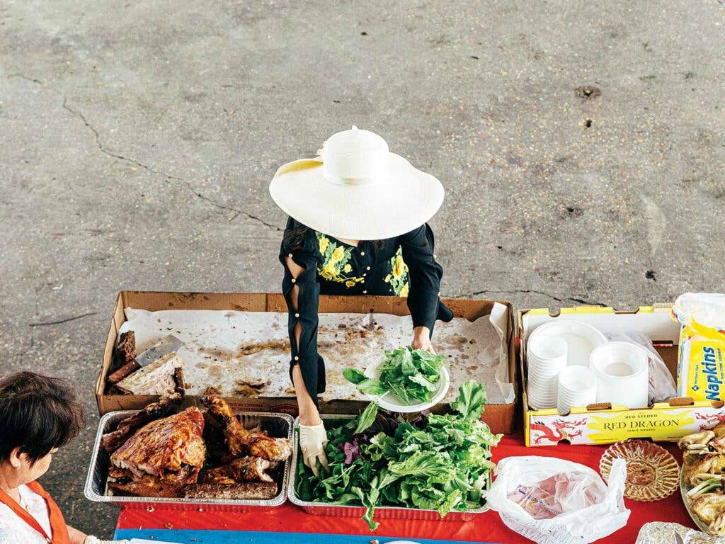 Woman makes plate of fresh herbs following the annual Blessing of the Fleet.