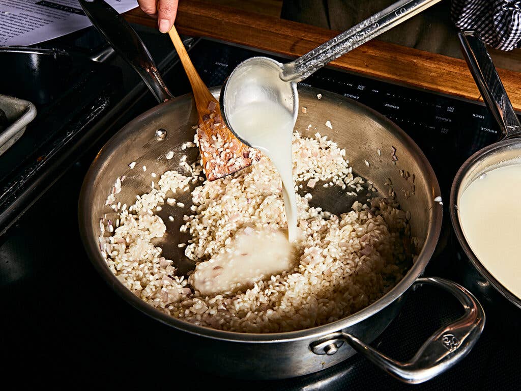 Gradually adding Parmigiano broth.