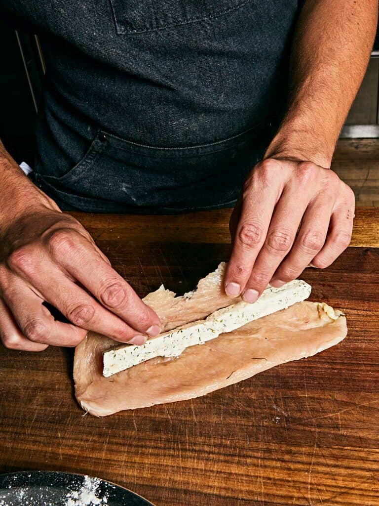 A thin log of compound butter rolled up inside the chicken cutlet.