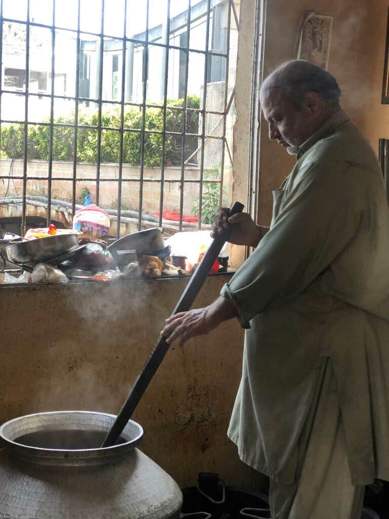 Maharaj starts to cook the vegetable biryani.