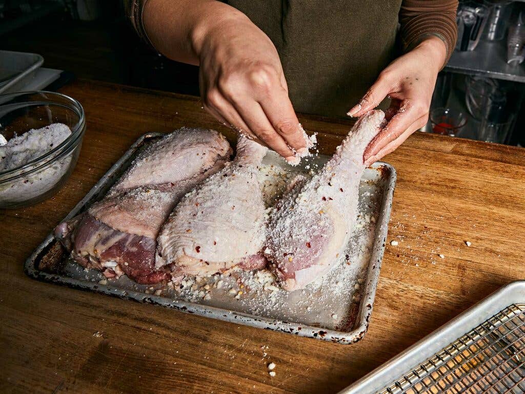 Packing the brine onto the meat in a thick layer.