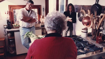 Saveur’s first editor-in-chief, ­Dorothy Kalins (right), and executive editor, Colman Andrews, in the Venice, Italy, kitchen of the late Marcella Hazan, whose back is toward the camera.