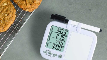 Kitchen timer and cookies on cooling rack.