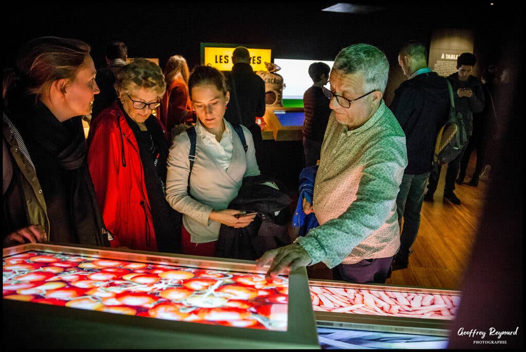 Guests visit interactive touchscreen exhibit at Lyon’s New ‘Cité Internationale de la Gastronomie’.