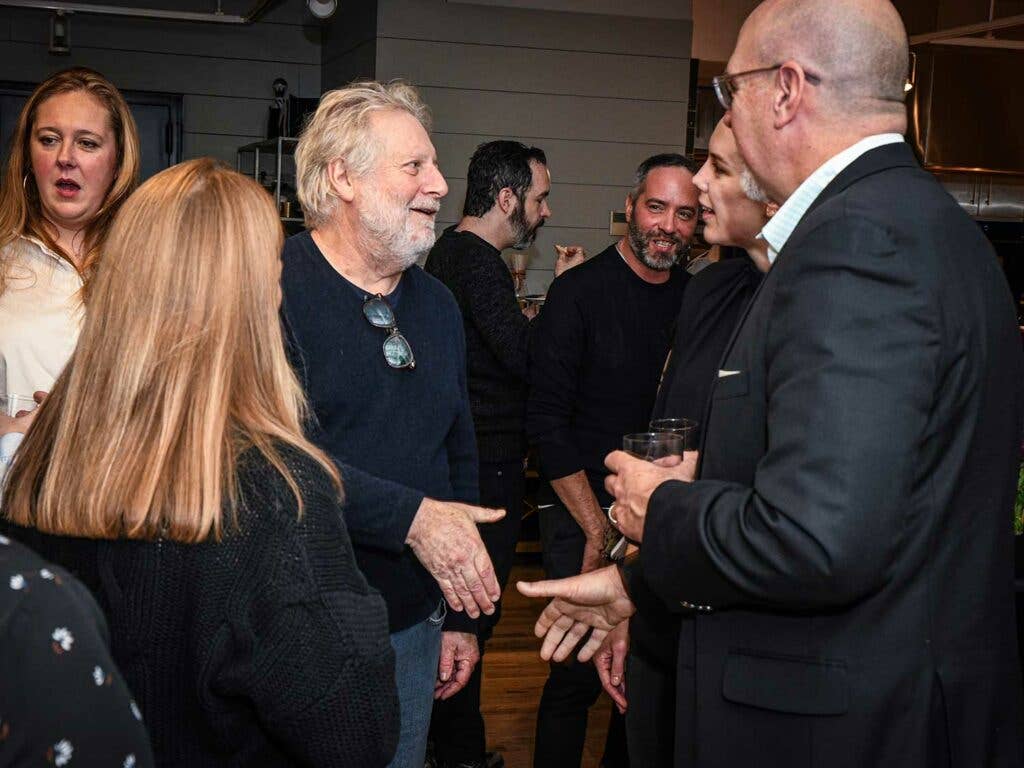 Chef Johnathan Waxman speaks with guests.