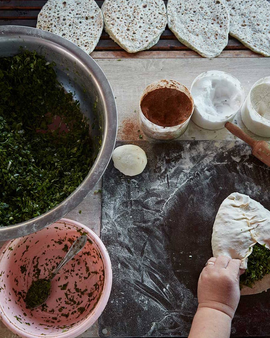 Making jingalov hats—flatbreads filled with greens and herbs.