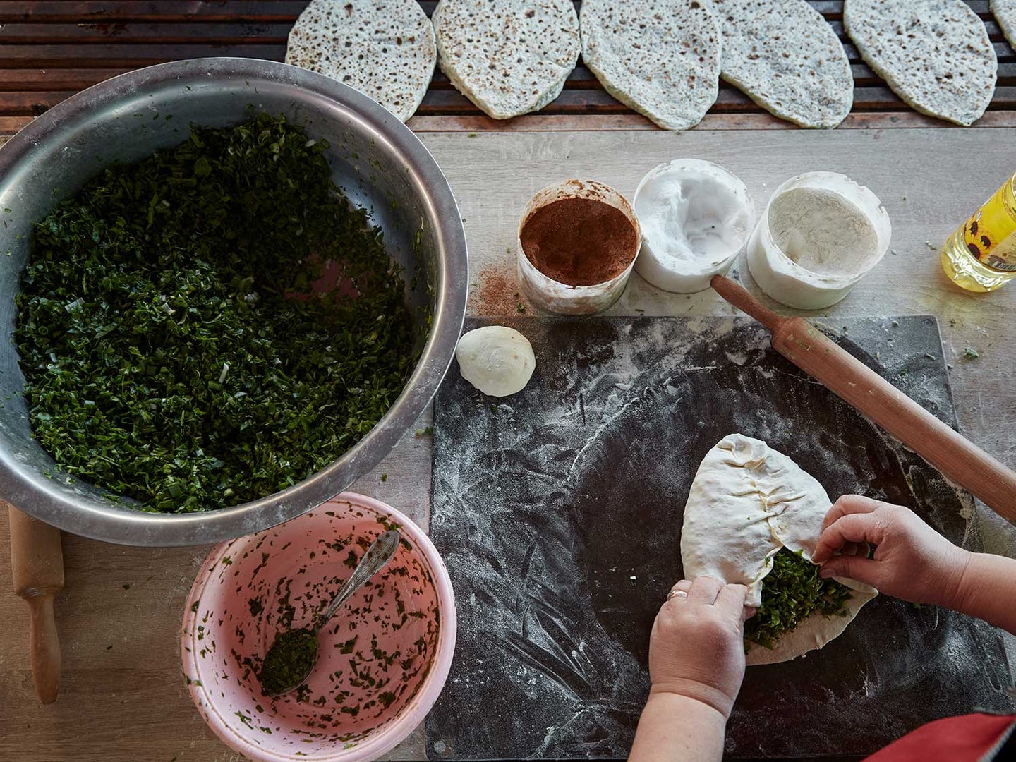 Making jingalov hats—flatbreads filled with greens and herbs.
