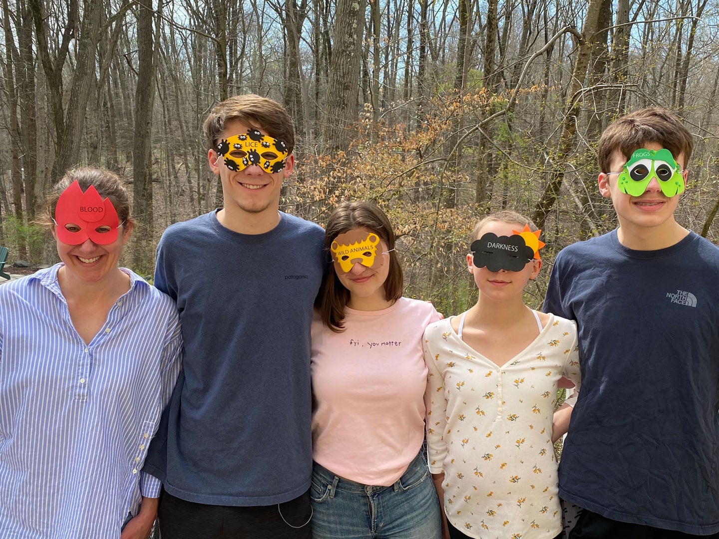 Author Catherine Tillman Whalen (far left, “blood”), her three children (Jack, second from left, “lice”; her daughter, second from right, “darkness”; her younger son, far right, “frogs”) and their “plus one”, Ava (center, “wild animals”) don masks representing a few of the ten plagues on Egypt.