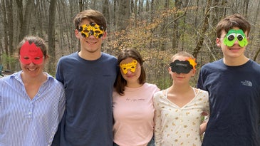 Author Catherine Tillman Whalen (far left, “blood”), her three children (Jack, second from left, “lice”; her daughter, second from right, “darkness”; her younger son, far right, “frogs”) and their “plus one”, Ava (center, “wild animals”) don masks representing a few of the ten plagues on Egypt.