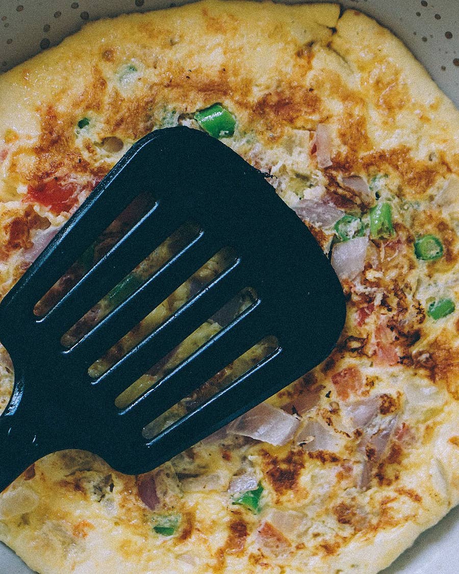 A spatula on top of an omelette