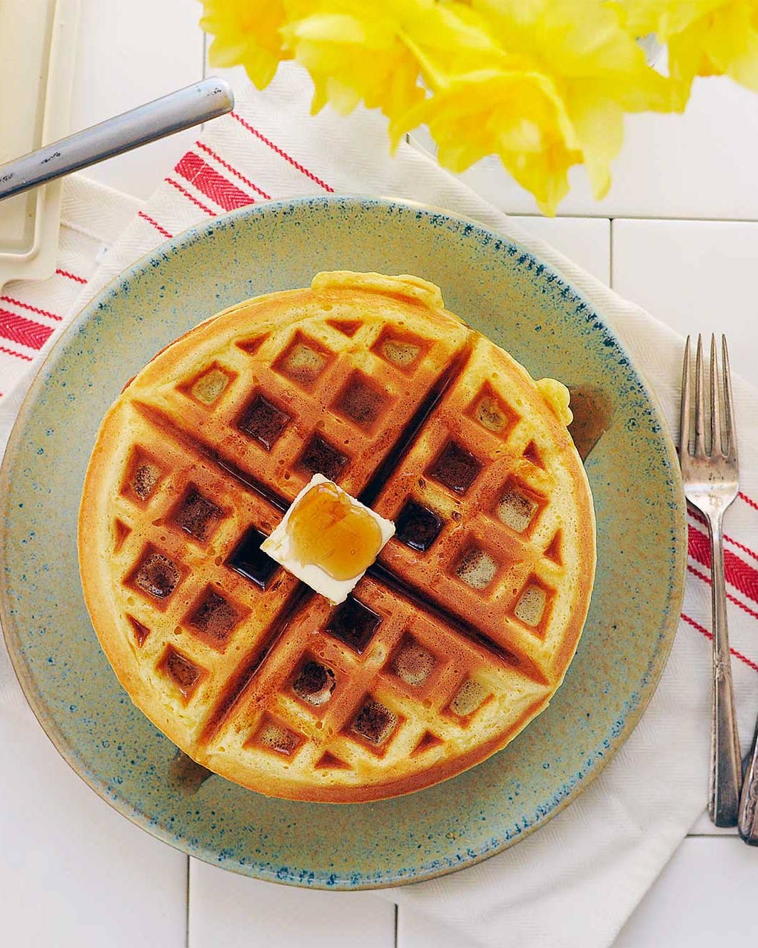 Waffle with dollop of butter and syrup