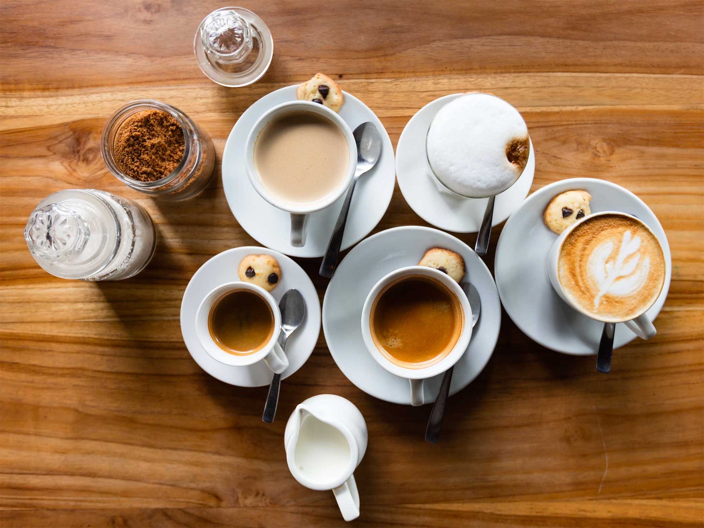Cups of coffee on a wooden table