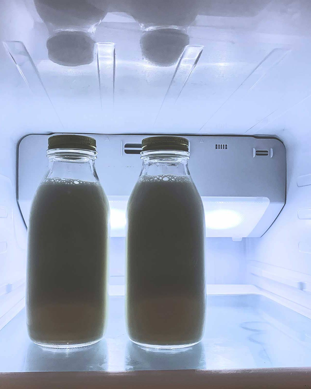 Bottles of milk in a refrigerator