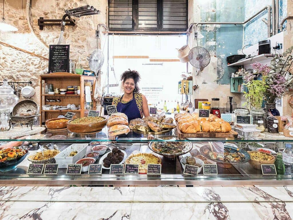 Woman standing behind counter at a bakery