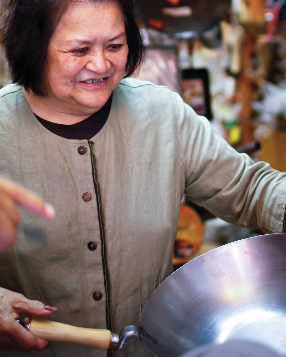 Asian woman holding a wok