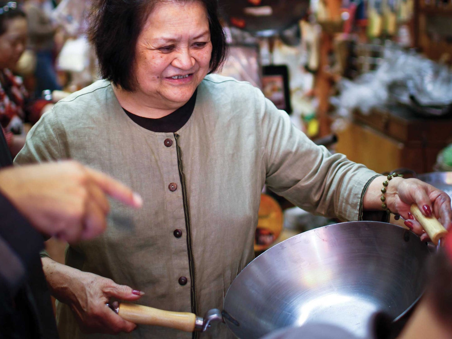 Asian woman holding a wok