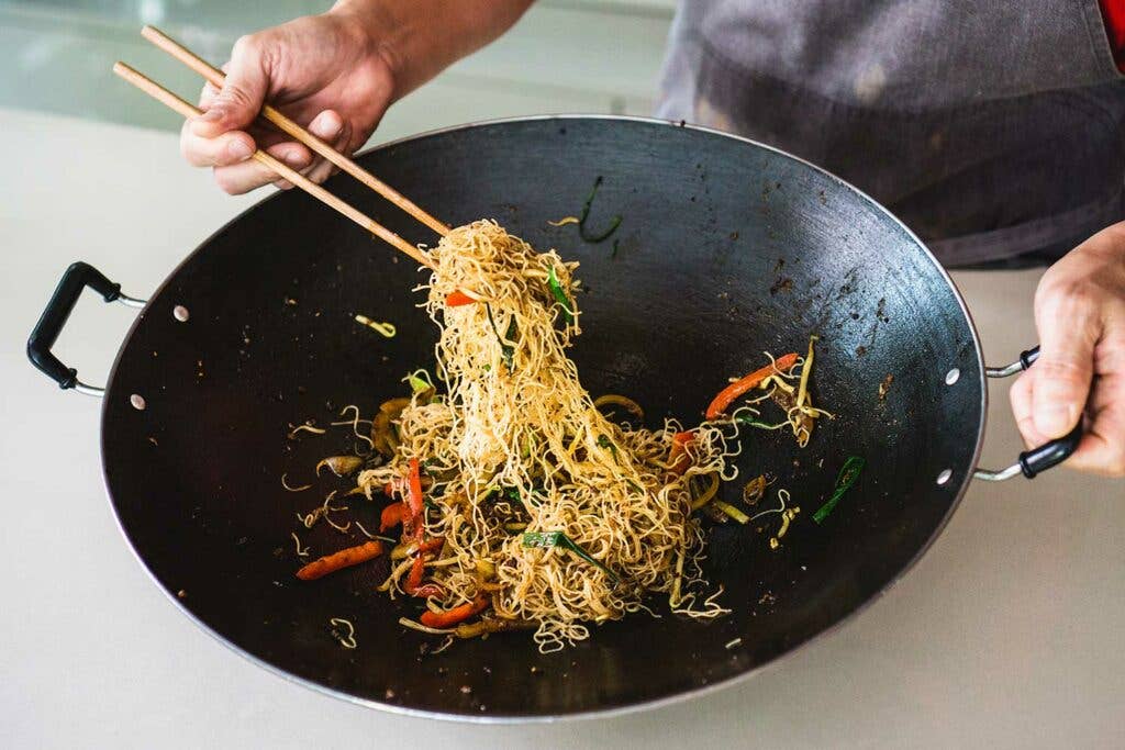 Add the vermicelli with the vegetables and sauce ingredients and stir-fry until the noodles are dry and cooked through.