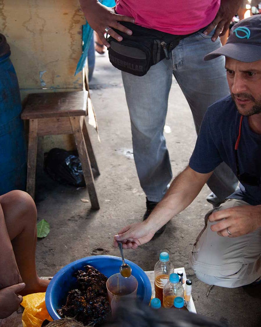 Peruvian chef Pedro Miguel Schiaffino speaks with a vendor at the Mercado de Belén in the Amazonian city of Iquitos.