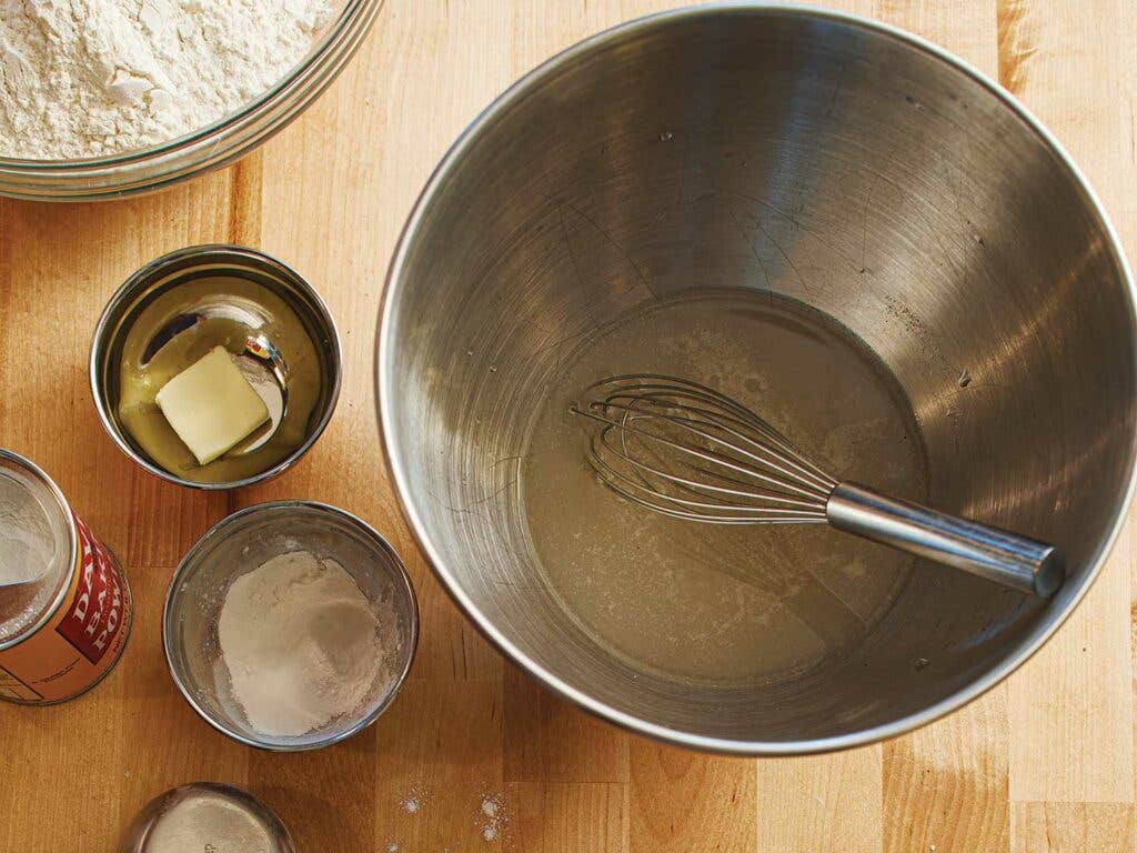 1 cup plus 2 tablespoons tepid water, 1¼ teaspoons sugar, and ¼ teaspoon dry instant yeast, 3¾ cups plus 2 tablespoons all-purpose flour, 2½ teaspoons baking powder, and 1½ teaspoons kosher salt.