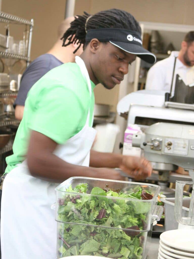 Interns prep salad greens for the cafe menus, and expand their fresh food vocabulary at the same time.