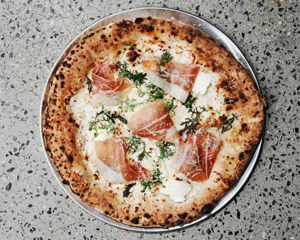 The Crudo pizza: ricotta, mozzarella, prosciutto, and mustard frills, on the menu at Pizzeria Vittoria.