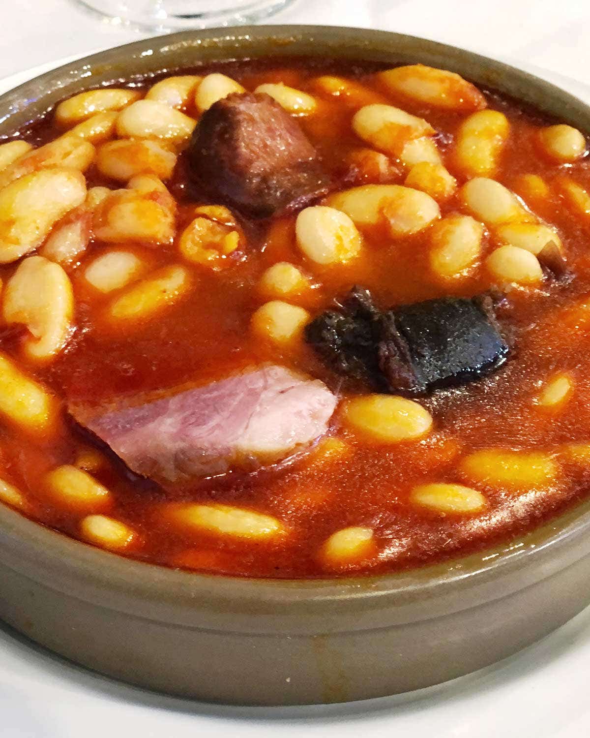 Fabada Asturiana (White Beans With Ham, Saffron, and Sausages) Fabada Asturiana - A comforting pork-and-beans stew from northern Spain.