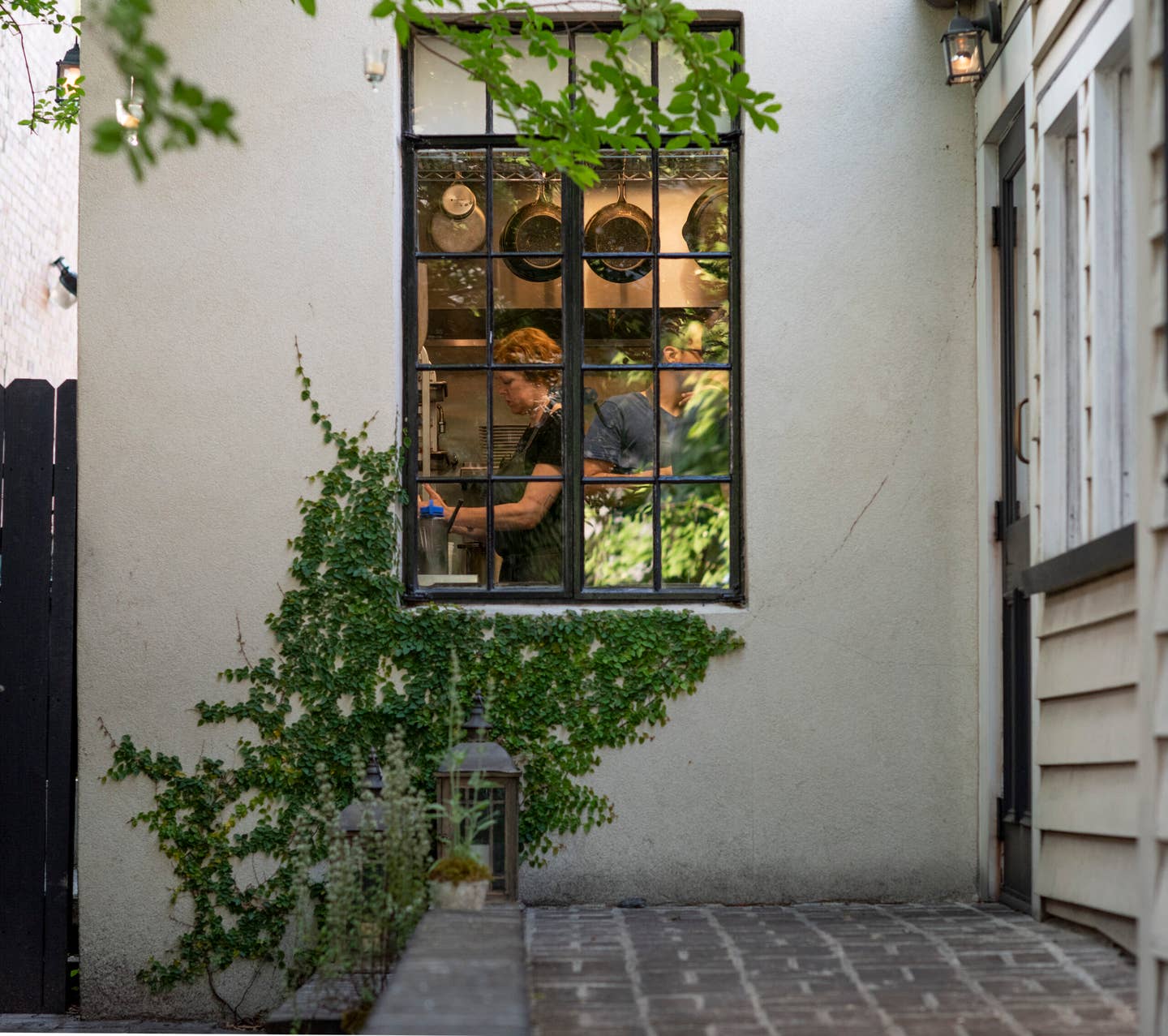 Chef Jill Mathias, seen through the kitchen window at Charleston’s Chez Nous.