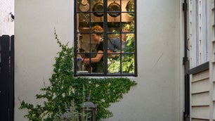 Chef Jill Mathias, seen through the kitchen window at Charleston’s Chez Nous.