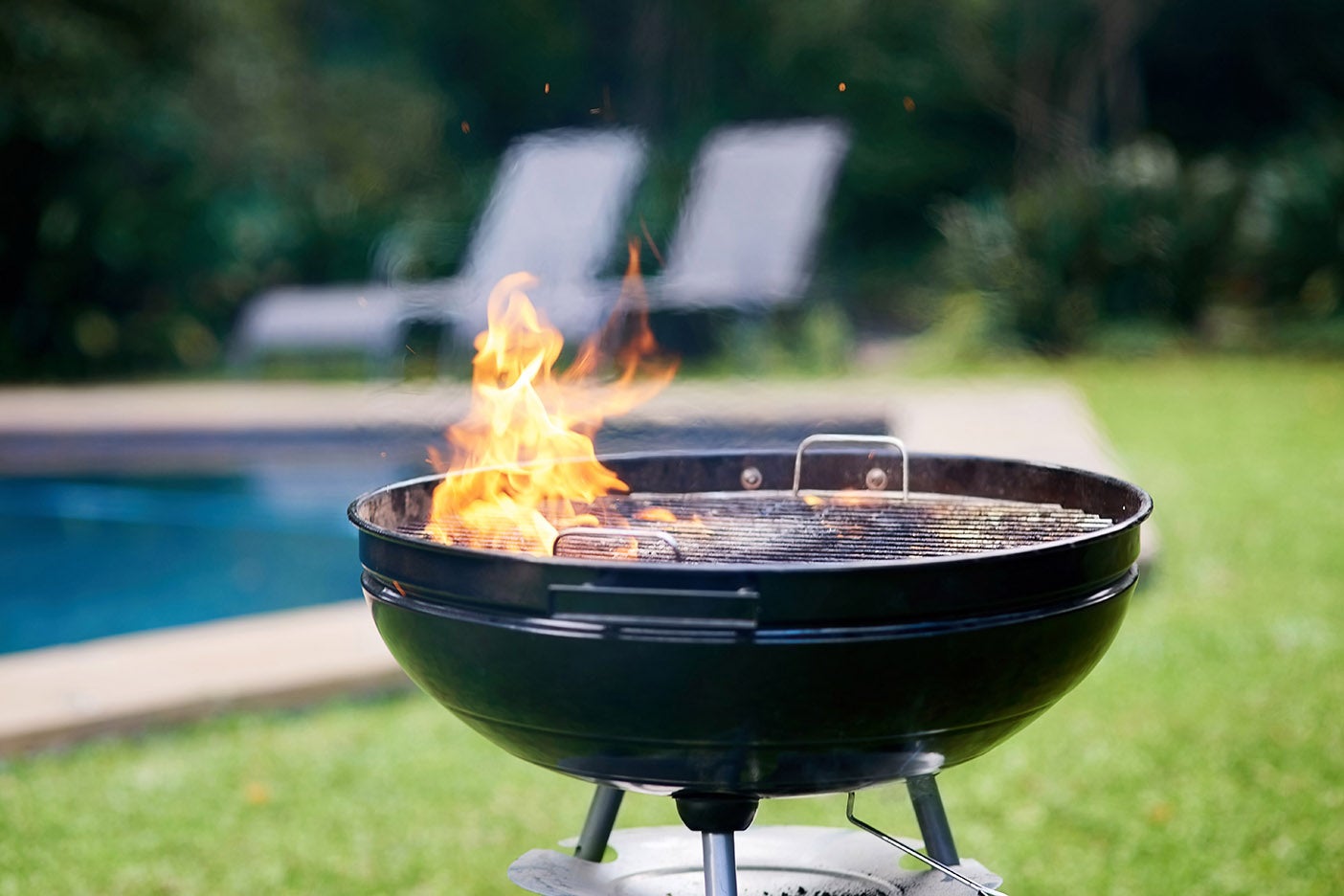 Cropped shot of a lit grill outside on a rainy day