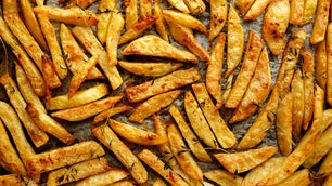 Seasoned fries on a baking sheet.