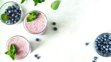 Two Glasses of blueberry milkshake. Top view