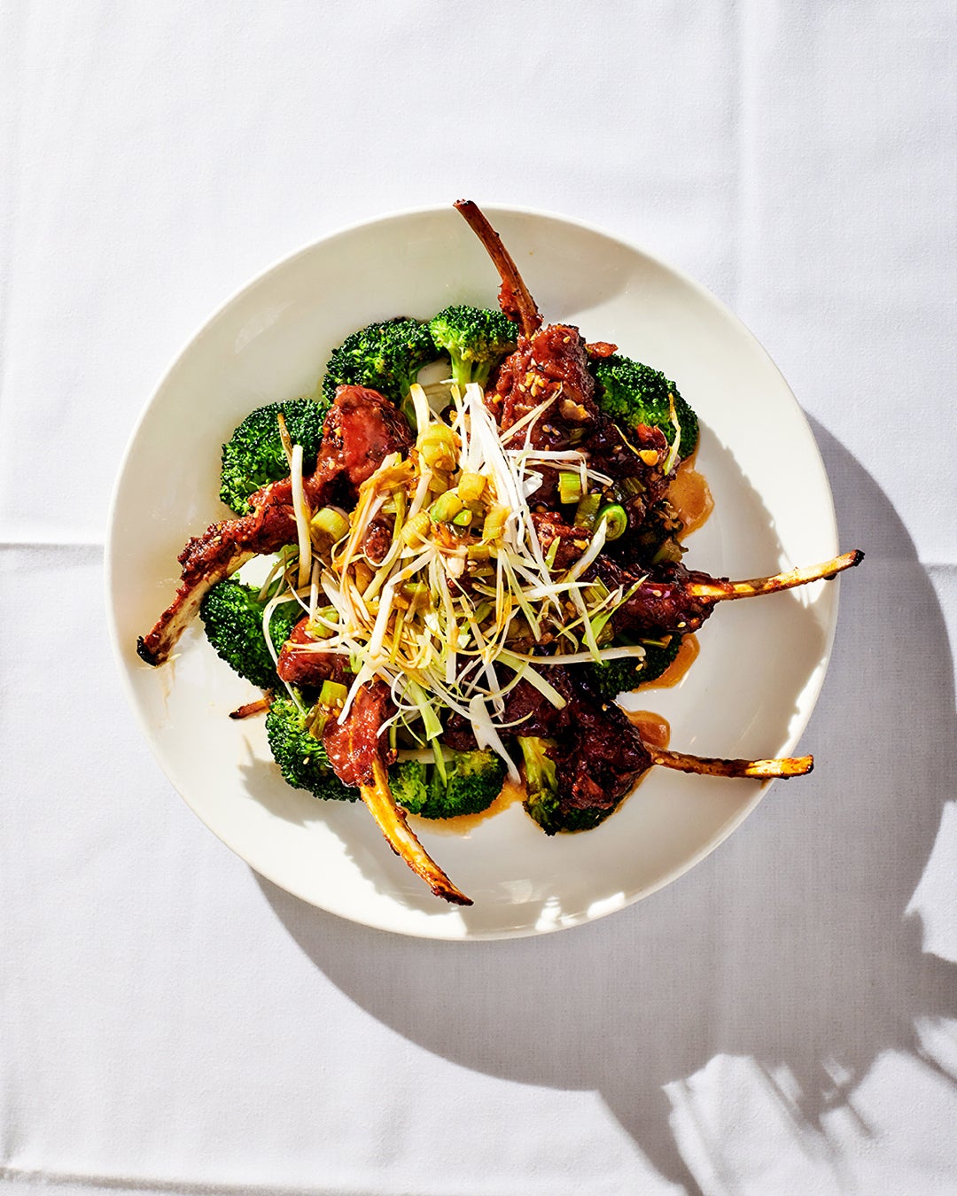 Peking-style lamb chops on top of broccoli